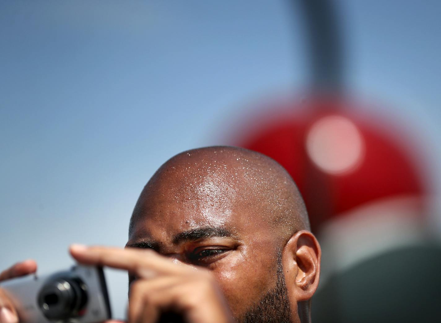 The re-opening day at the Minneapolis Sculpture Garden Saturday, June 10, 2017, in Minneapolis, MN. Here, independent journalist and filmmaker Ralph Crowder III of Minneapolis, shows signs of the extreme heat while documenting the re-opening.] DAVID JOLES &#xef; david.joles@startribune.com re-opening day at the Minneapolis Sculpture Garden