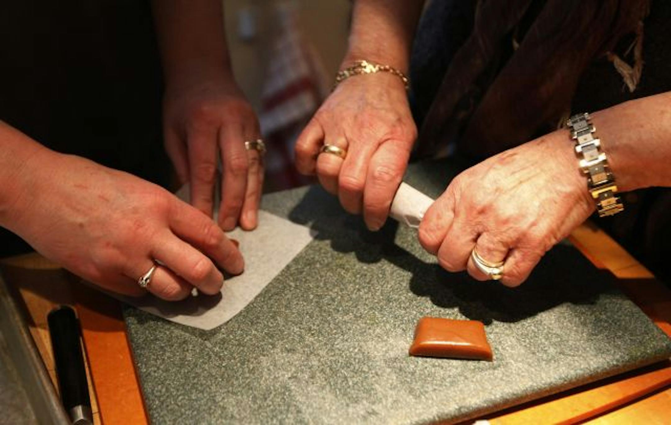 Brenda and Amy put the finishing touches on a batch of caramels.