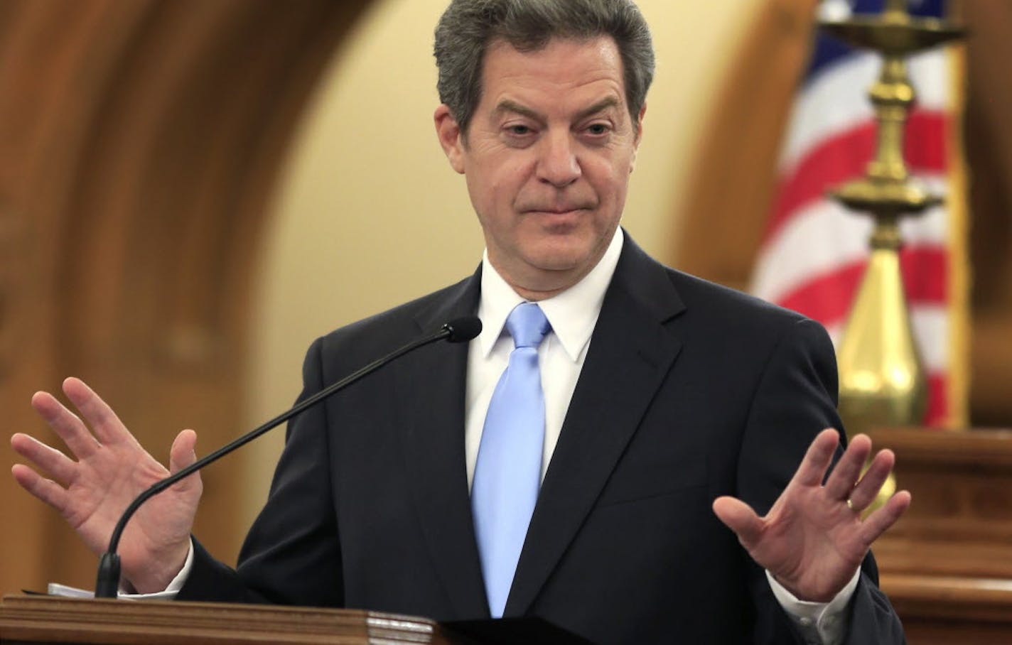 FILE - In this Jan. 12, 2016, file photo, Kansas Gov. Sam Brownback speaks to the legislature in Topeka, Kan. Kansas taxpayers have been picking up the tab for state officials and legislators to fly in the state-owned executive aircraft to attend out-of-state sports events and take trips with family and friends, according to documents obtained by The Associated Press. Brownback took a trip to Memphis, Tenn., on Jan. 2 to watch the Liberty Bowl contest between Kansas State University and Arkansas