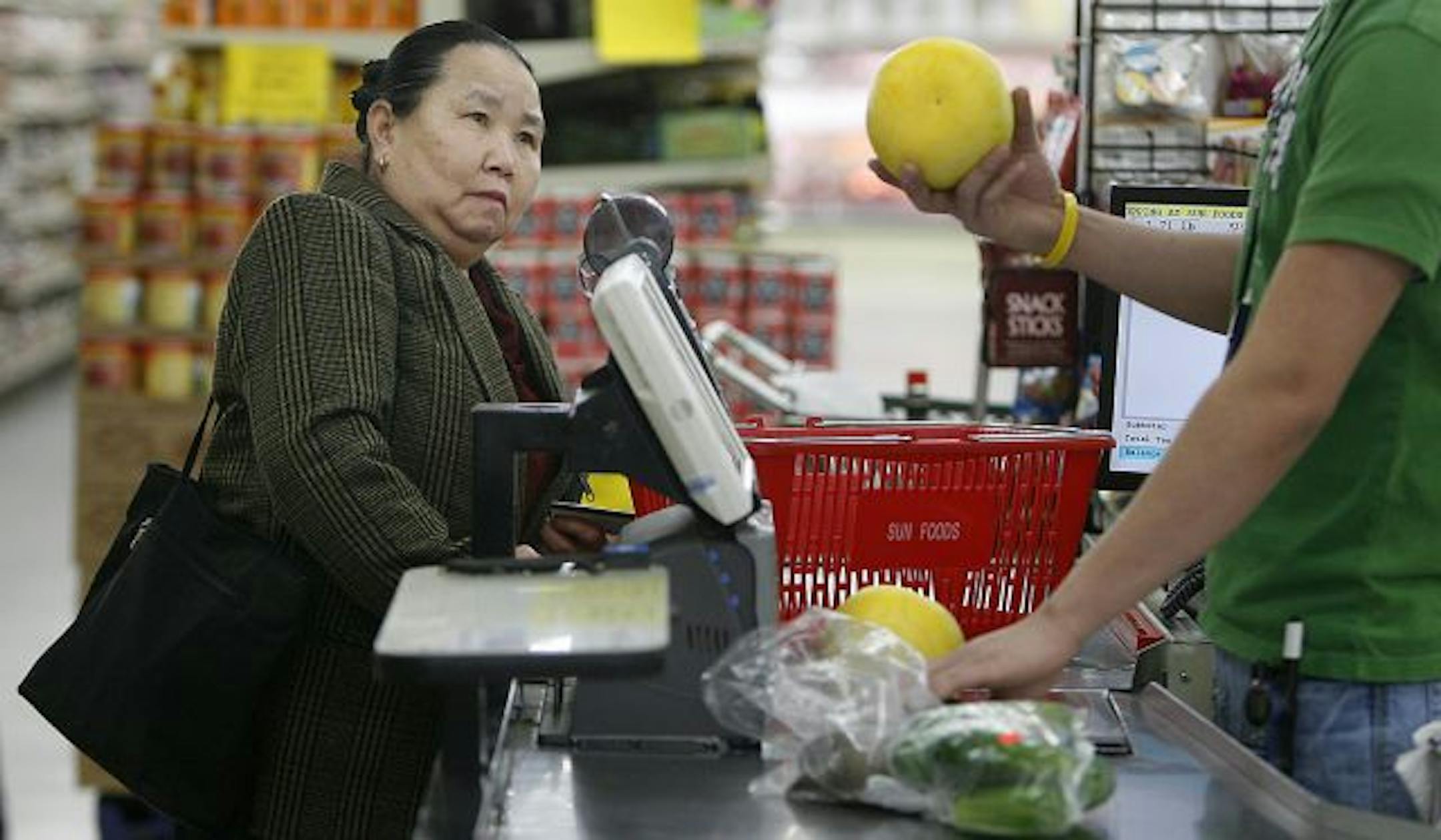 Chee Yang took a closer look at the grapefruits she purchased with Minnesota's food stamp system. The first major federal stimulus money targeting low-income people is slated to arrive in Minnesota on Wednesday . The 317,000 Minnesotans relying on food stamps will get a 14 percent increase in their monthly benefits.