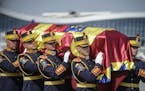 An honor guard soldiers carry the flag-draped coffin of Anne of Romania, wife of Romania's last monarch King Michael, before a religious service, in O