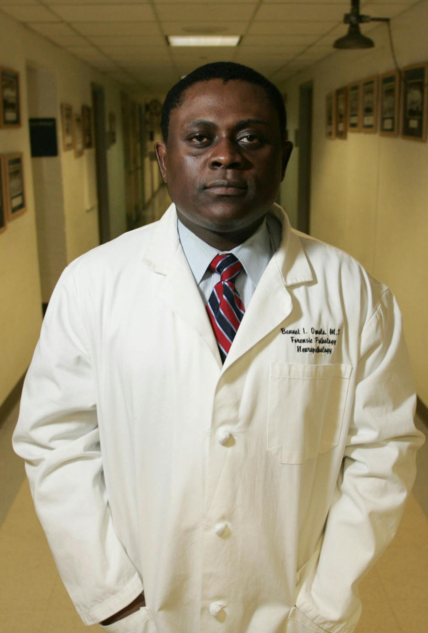 FILE &#xf3; Dr. Bennet Omalu, who identified a degenerative brain disease linked to repeated head hits, at the University of Pittsburgh Medical Center Presbyterian Hospital in Pittsburgh, Jan. 2007. Will Smith portrays Omalu in the film &#xec;Concussion.&#xee; In dozens of emails unearthed by hackers, Sony Pictures executives and others discussed altering the script and marketing the movie more as a whistle blower story than as a condemnation of the NFL. (Lisa Renee Kyle/The New York Times) ORG