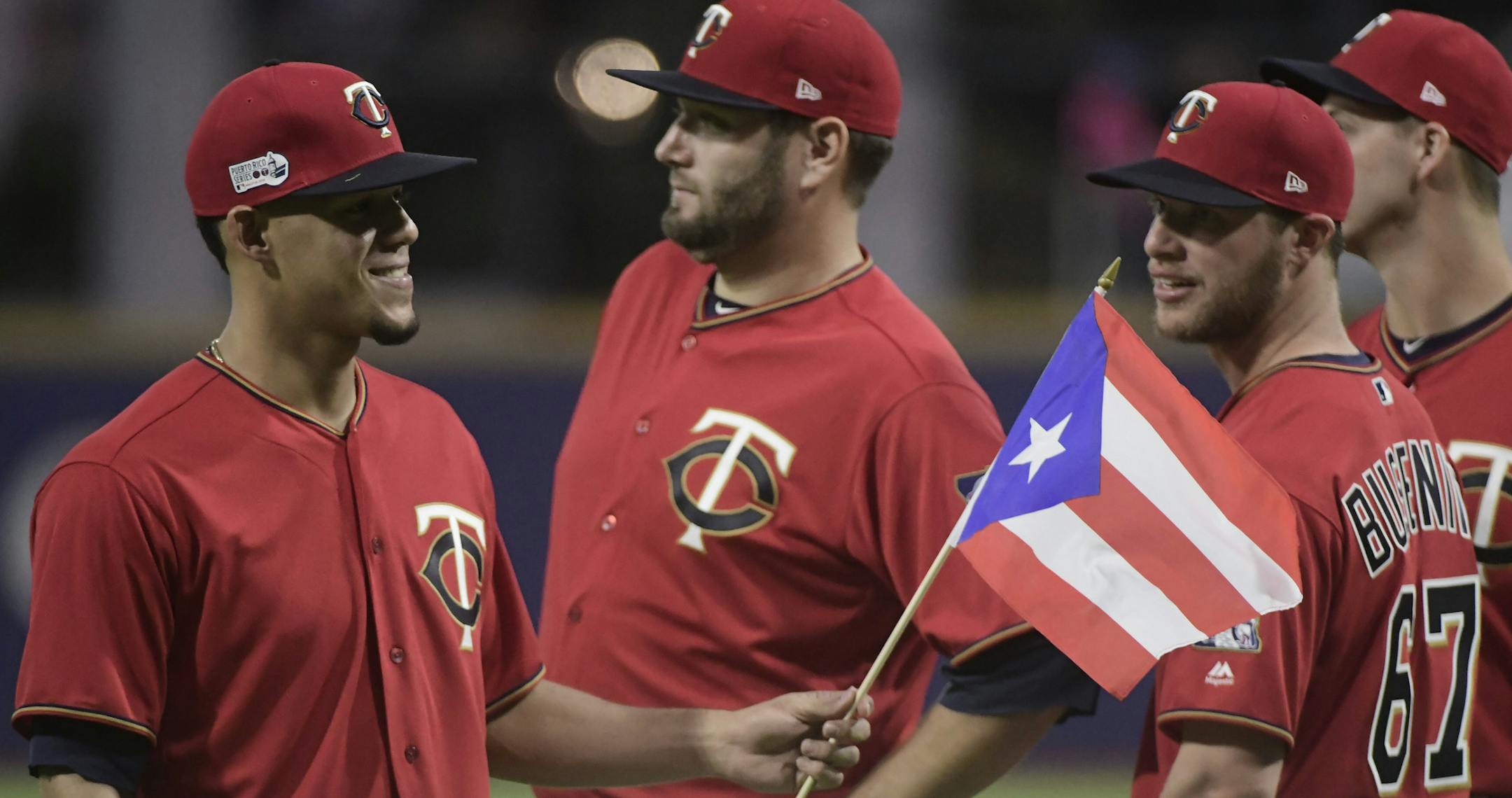 CORRECTS RIVAL TEAM TO CLEVELAND INDIANS - Minnesota Twins starting pitcher Jose Berrios enters the field holding a Puerto Rican flag before game one of a two-game MLB Series against the Cleveland Indians at Hiram Bithorn Stadium in San Juan, Puerto Rico, Tuesday, April 17, 2018. (AP Photo/Carlos Giusti)