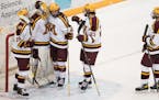Minnesota forward Blake McLaughlin (27) gave a hug to goaltender Jack LaFontaine (45) after a victory over Michigan last March.