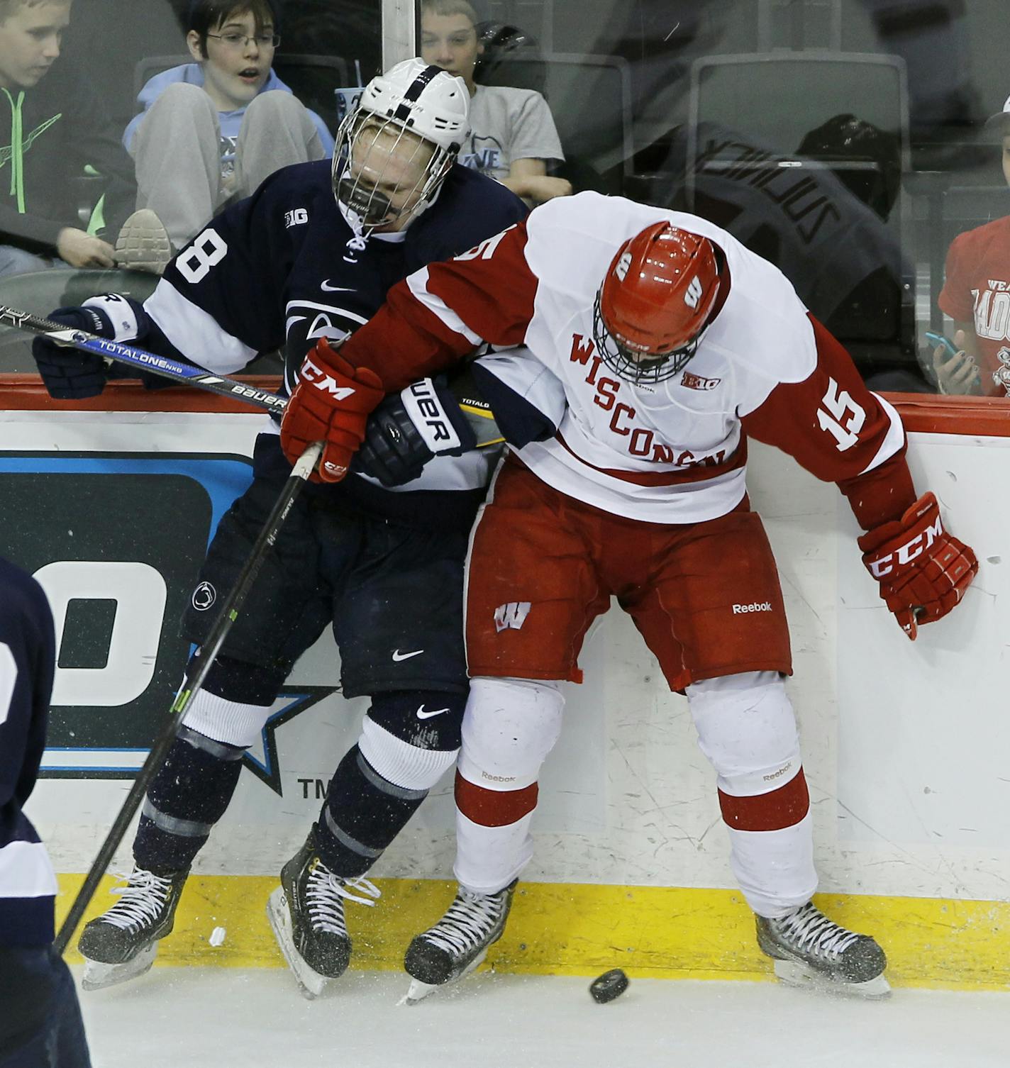 Wisconsin forward Morgan Zulinick (15) pins Penn State forward Taylor Holstrom, left, against the boards as they battle for the puck during the third period of a college hockey game in the semifinals of the Big 10 Conference tournament St. Paul, Minn., Friday, March 21, 2014. Wisconsin won 2-1. (AP Photo/Ann Heisenfelt)