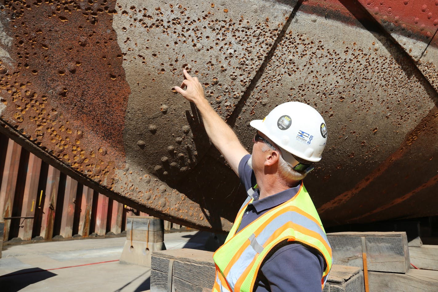 Duluth Entertainment Convention Center property maintenance director Steve Rankila pointed to rivet damage by metal-eating bacteria on the William A. Irvin museum ship. The vessel is sitting in dry dock for hull repair.