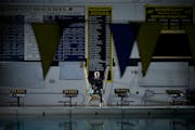 Rosemount diver Lucas Gerten posed in his work environment, with his accomplishments showing on the wall behind him.