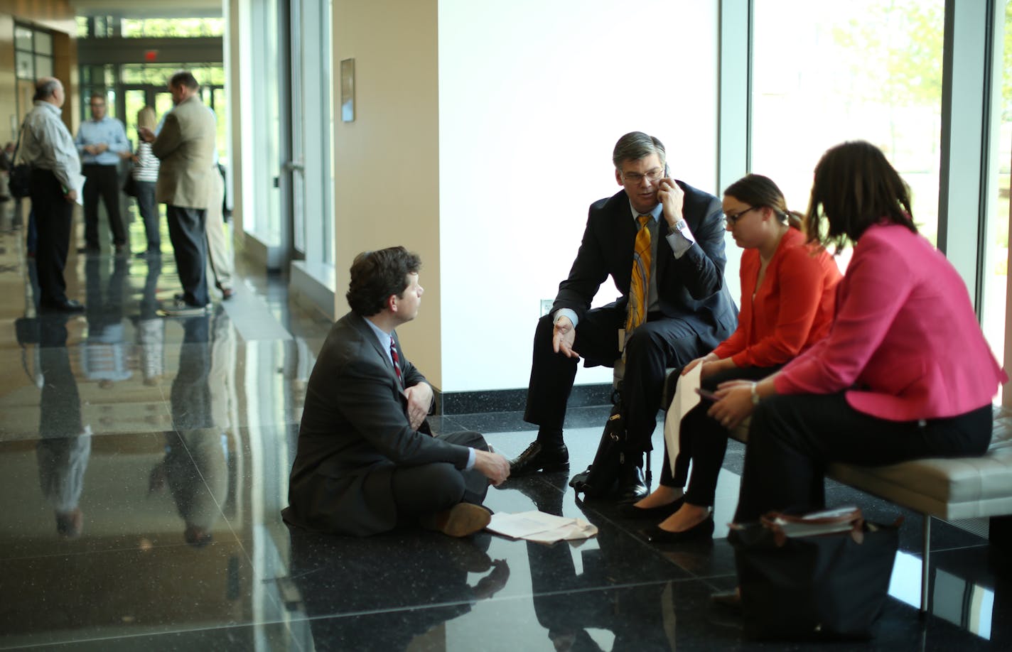 With both the House and Senate in recess Sunday afternoon, Rep. Dennis Smith, R-Maple Grove, on floor, Sen. Eric Pratt, R-Prior Lake, and House Majority Leader Joyce Peppin, R-Rogers, right, and an unidentified staffer confered in the Senate Building Sunday afternoon. ] JEFF WHEELER &#xef; jeff.wheeler@startribune Legislators worked Sunday to agree on spending, tax cuts, and borrowing ahead of their midnight adjournment deadline Sunday, May 22, 2016.