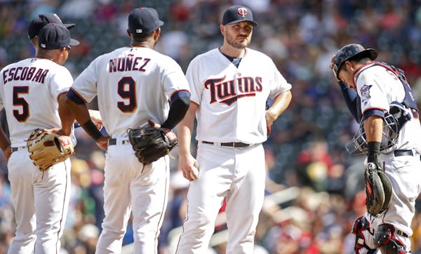 Minnesota Twins relief pitcher Kevin Jepsen, second from the right, awaits the manager to relinquish the ball against the Tampa Bay Rays in the ninth 