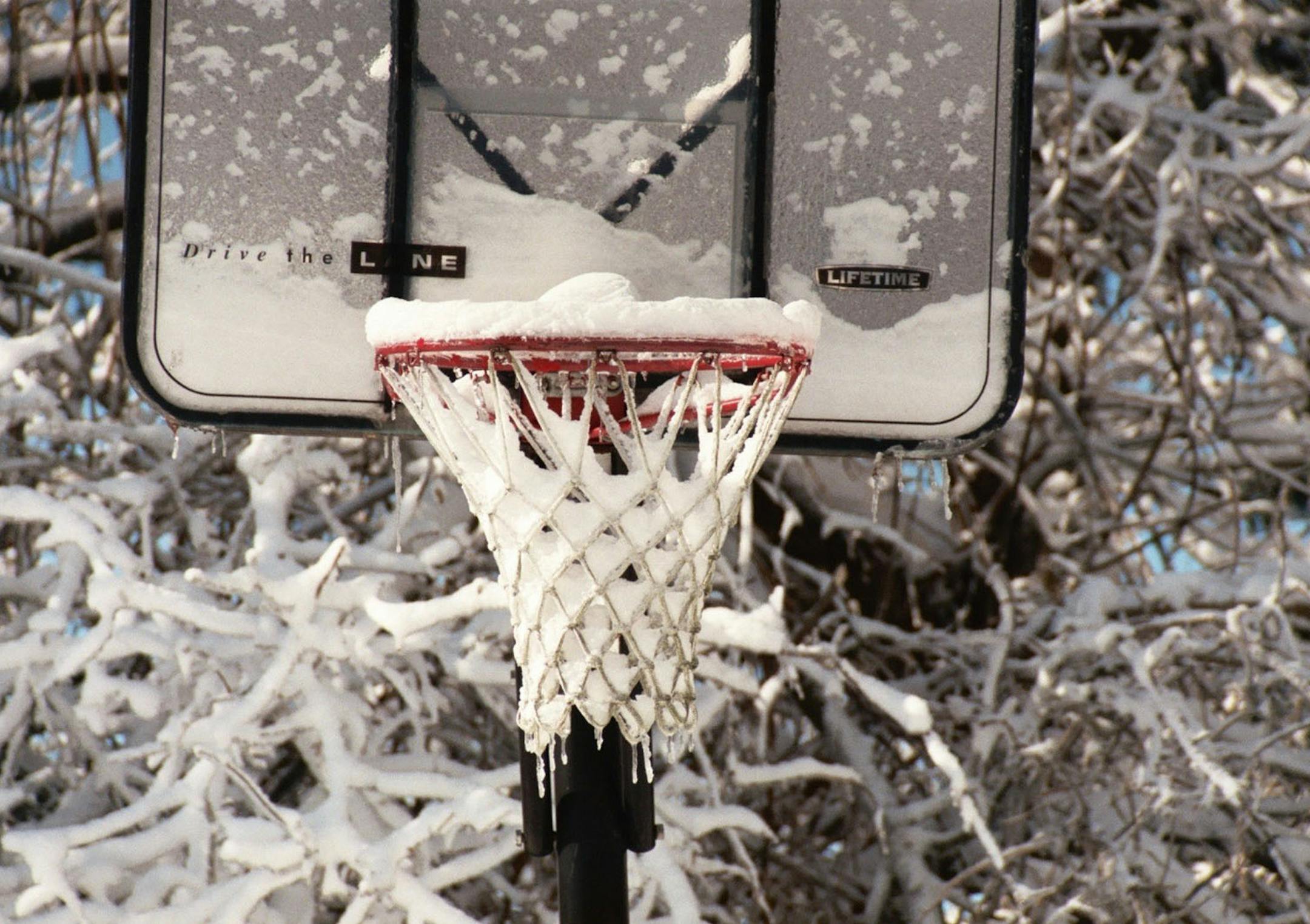 Fresh snow and ice foil any hoop dreams in Middleton, Wis. By photographer Sue Peterson of St. Paul. [focus030517