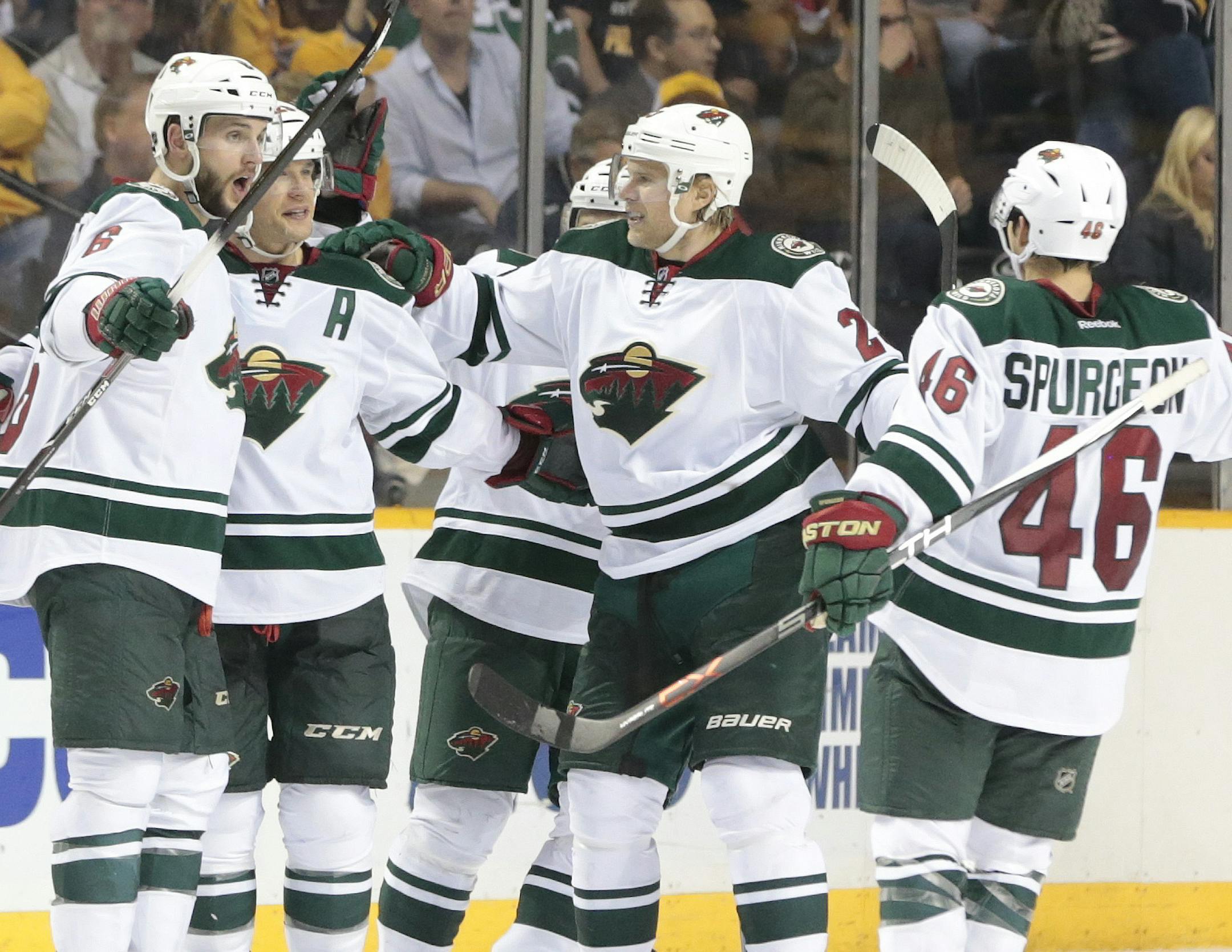 Minnesota Wild right wing Jason Pominville, second from left, celebrates with his teammates after scoring a goal against the Nashville Predators in the third period of an NHL hockey game Thursday, April 9, 2015, in Nashville, Tenn. The Wild won 4-2. (AP Photo/Mark Humphrey)