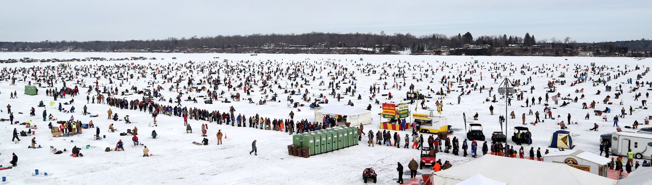 What appears as a long long for the portable bathrooms is actually a line of successful fishing contestants waiting to register their fish on Hole in the Day Bay of Gull Lake during the Ice Fishing Extravaganza Saturday, Feb. 6, 2016, in Brainerd, MN.