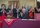 Governor Walz gestured a sign of respect to Ojibwe Elders and Lieutenant Governor Peggy Flanagan after he signed a bill to launch the first official m