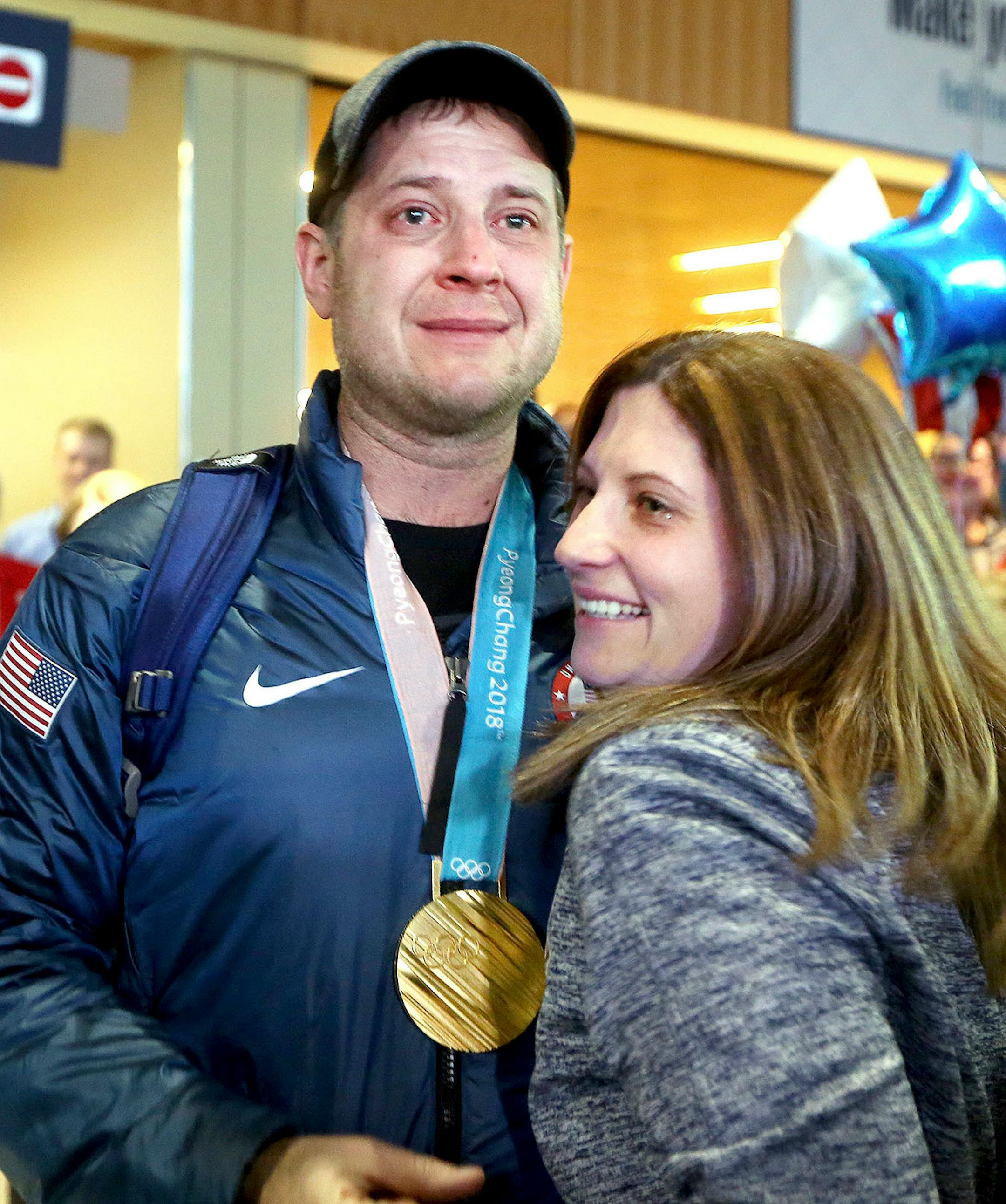 John Shuster of the Duluth curling team and his wife Sara tear up when they reunite at the Duluth International Airport Monday before a huge crowd. Bob King / rking@duluthnews.com