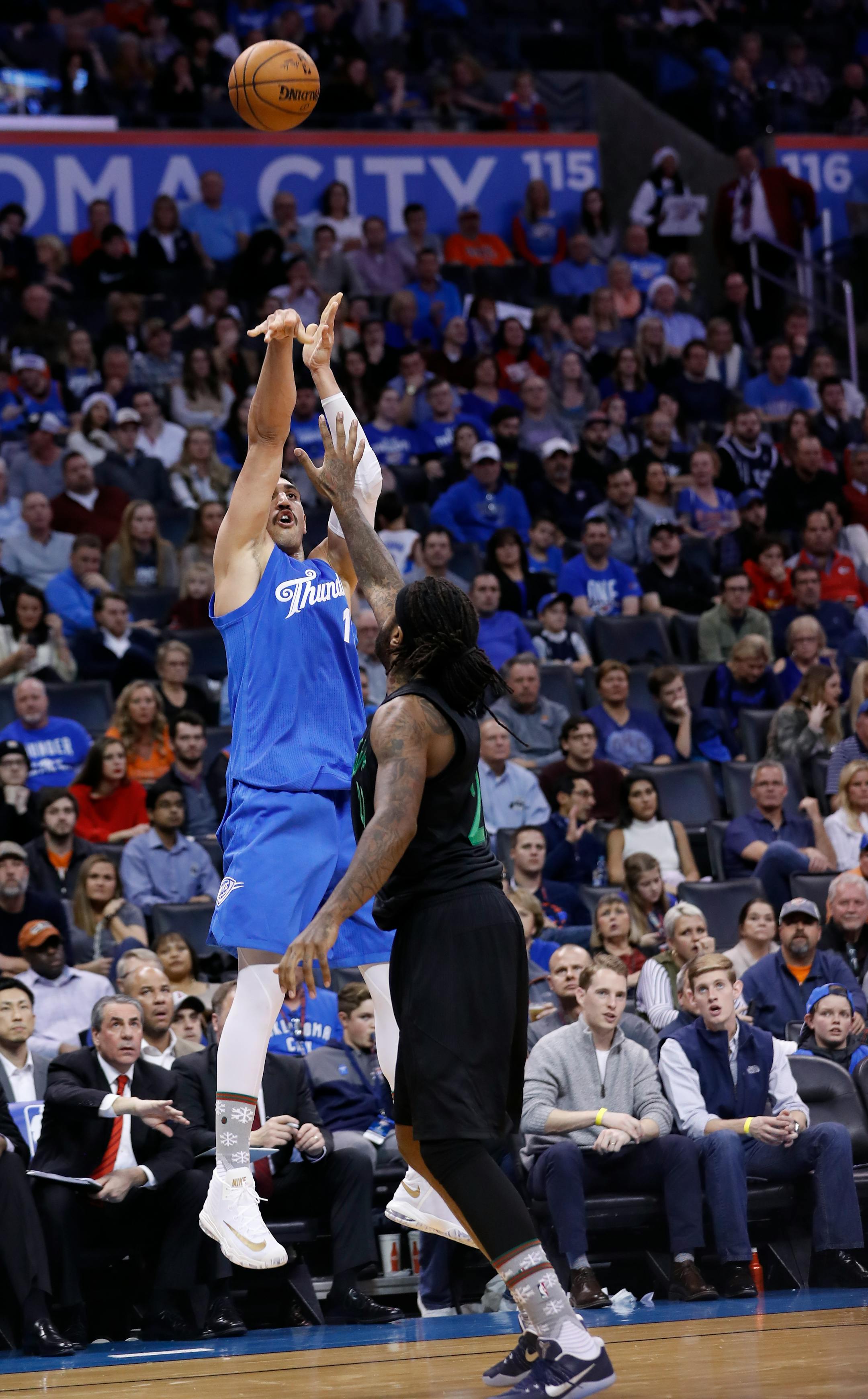 Oklahoma City Thunder center Enes Kanter (11) shoots over Minnesota Timberwolves forward Jordan Hill (27) during the second half of an NBA basketball game in Oklahoma City, Sunday, Dec. 25, 2016. Oklahoma City won 112-100. (AP Photo/Alonzo Adams)