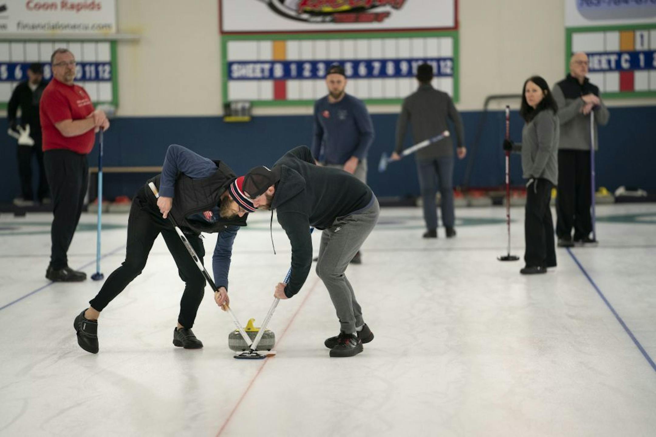 Brad Schwantke and Derek Doty swept in front of the stone during their curling league at the Four Seasons Curling Club in Blaine, Minn., Wednesday, January 29, 2020.