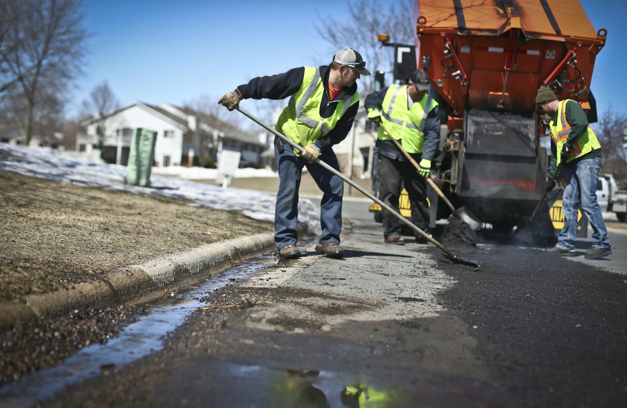 Josh Mallinger laid black top over potholes with other city crew on Monday , April 1, 2013 in Burnsville, Minn. ] (RENEE JONES SCHNEIDER * reneejones@startribune.com) call reporter on celll to confrim time = 612 310 1077