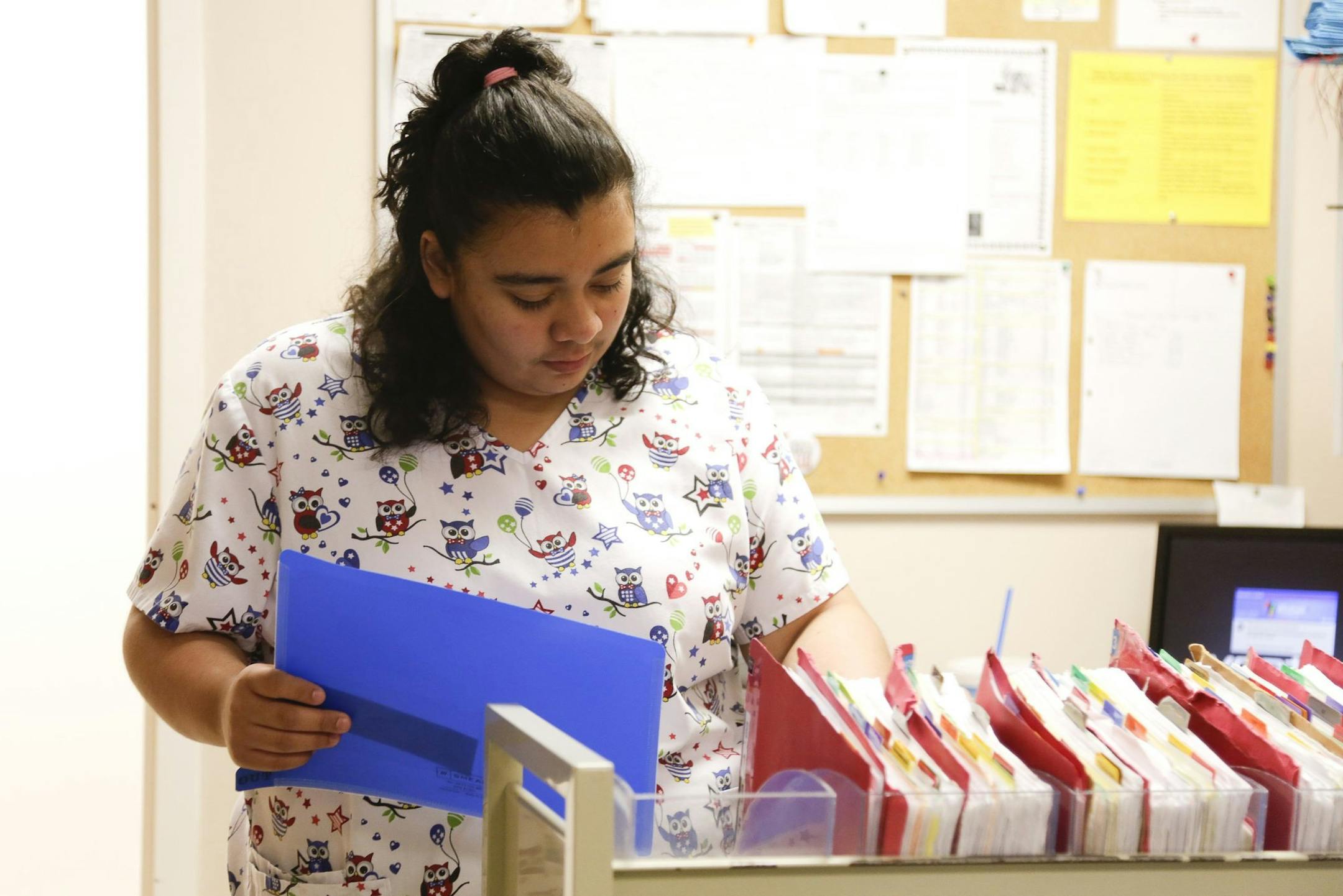 Jessica Lopez-Cerrano works at the Family Health Center, in Louisville, Kentucky, August 28, 2013. She worked for the mayor's SummerWorks program and now works in medical records- prepping and pulling records at the health center. For the fourth consecutive summer, teen employment has stayed anchored around record lows, prompting experts to fear that a generation of youth is likely to be economically stunted with lower earnings and opportunities in years ahead. (Bill Luster/MCT) ORG XMIT: 114262