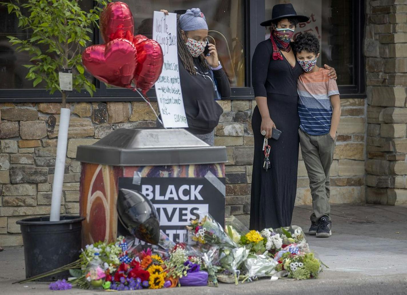 "It's devastating," said Zola Richardson as she held her son Gabriel 11, close as she stood to pay respect May 26 near the site where George Floyd died after a confrontation with Minneapolis police.