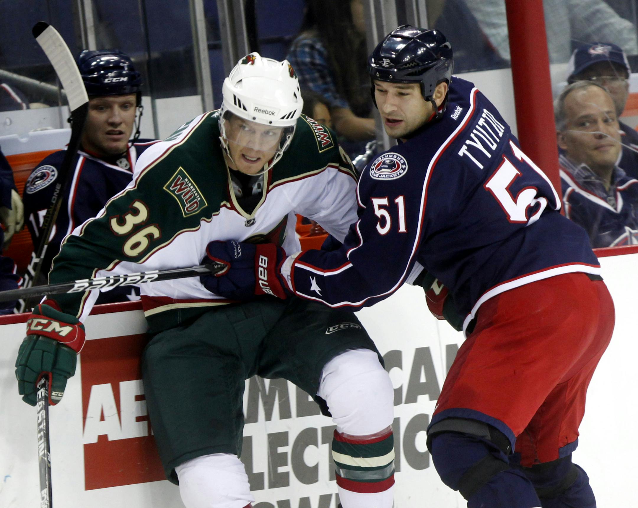 The Blue Jackets' Fedor Tyutin (51) tried to keep the Wild's Nick Johnson from the puck during the first period in Columbus.