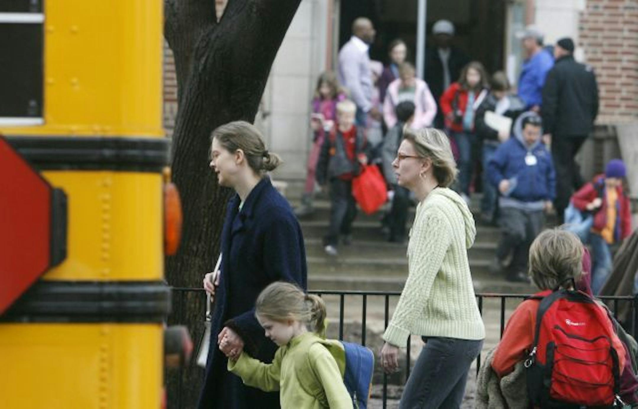 Parents escort some students from Clara Barton Open School at the close of the school day, following the lockdown Wednesday at all Minneapolis Public Schools.