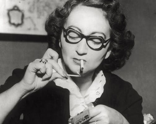 The writer Alba de Cespedes y Bertini photographed while lighting a cigarette. 1950s. (Photo by Mondadori via Getty Images)