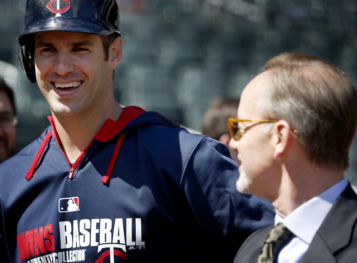 Minnesota Twins Joe Mauer spoke with team owner Jim Pohlad during batting practice before the Twins home opener at Target Field.