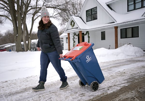 Emily Johnson Piper hauled her organic recycling can to the curb on Thursday, Jan. 27, 2022 in Golden Valley. As of this month, Hennepin County requir
