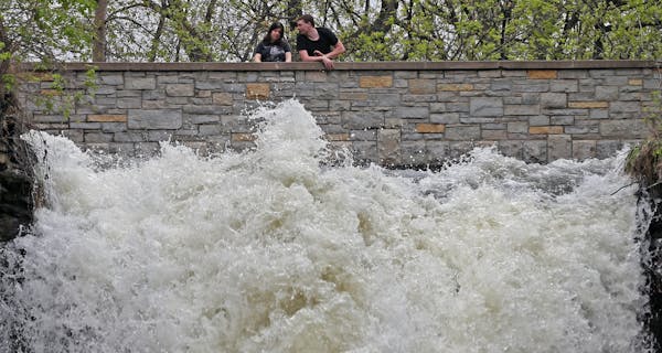 A couple checked out the fast water flow just above Minnehaha Falls.