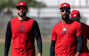 Carlos Correa and Byron Buxton leave a practice field during Twins spring training in Fort Myers, Fla., on Feb. 17.