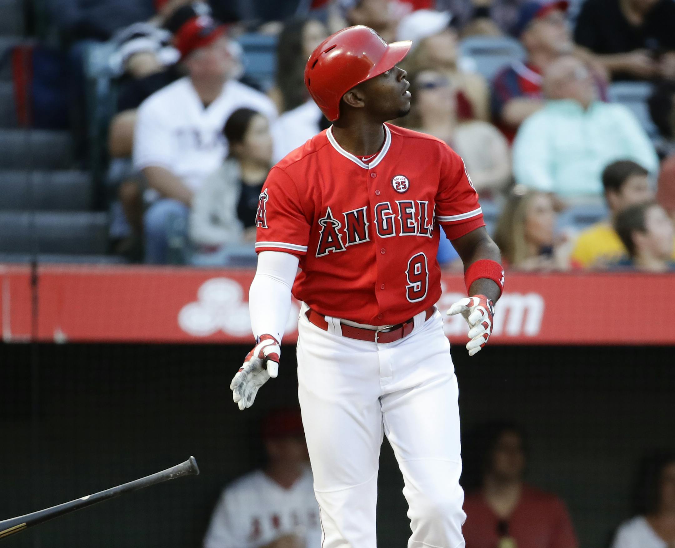 FILE - In this Sept. 16, 2017, file photo, Los Angeles Angels' Justin Upton watches his home run against the Texas Rangers during the first inning of a baseball game, in Anaheim, Calif. Outfielder Justin Upton is staying with the Angels, agreeing to a new five-year, $106 million contract. The Angels announced the deal Thursday, Nov. 2, 2017, with Upton, their late-season trade acquisition. (AP Photo/Chris Carlson, File)