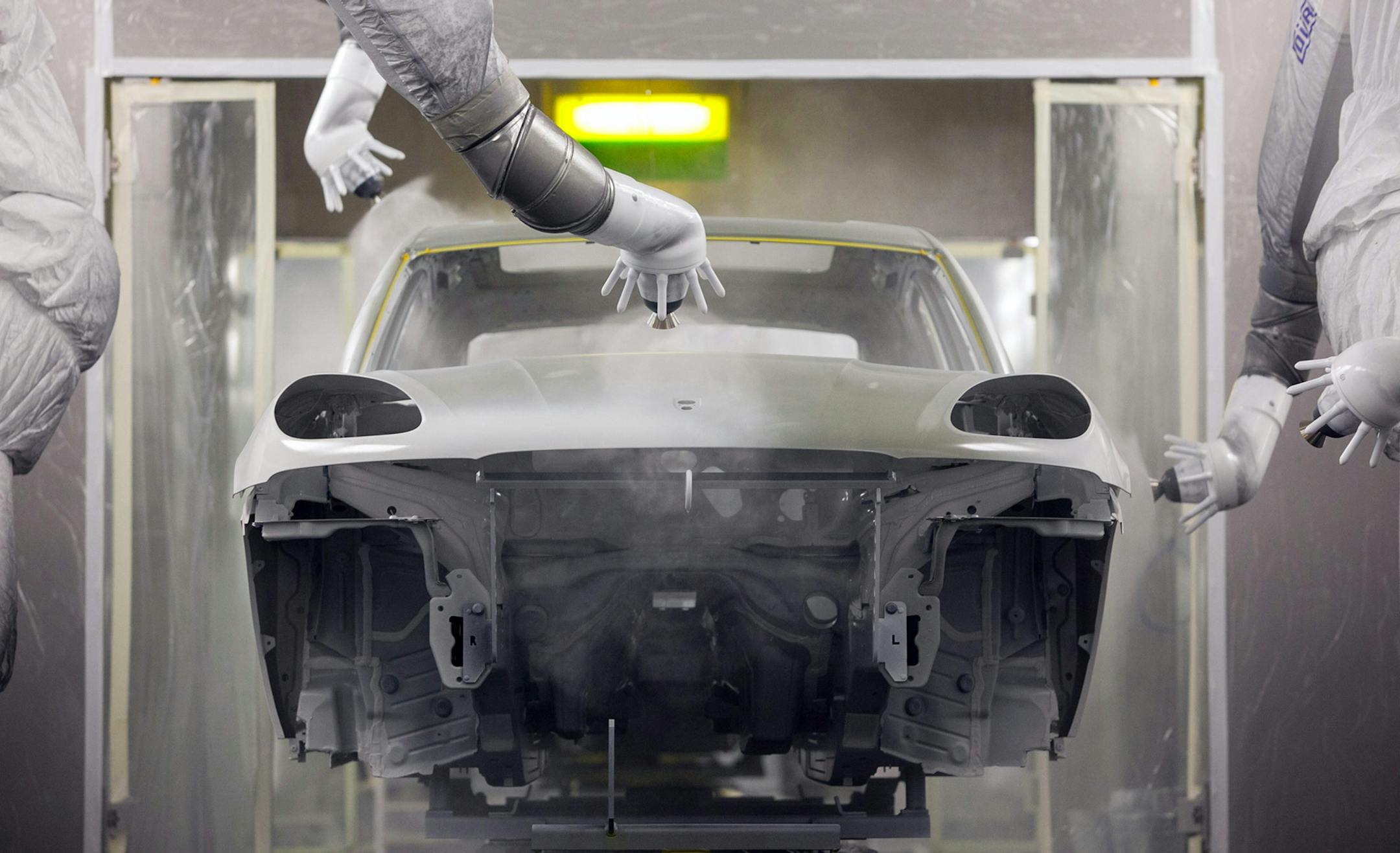 Robotic arms spray paint onto the chassis of a Porsche Macan sport-utility vehicle inside the paint shop at the newly expanded Porsche factory in Leipzig, Germany. The factory is one sign of a growing economic revival in Germany's formerly communist east. lllustrates GERMANY (category i) by Leon Mangasarian (c) 2014, Bloomberg News. Moved: Saturday, April 5, 2014 (MUST CREDIT: Bloomberg News photo by Krisztian Bocsi).