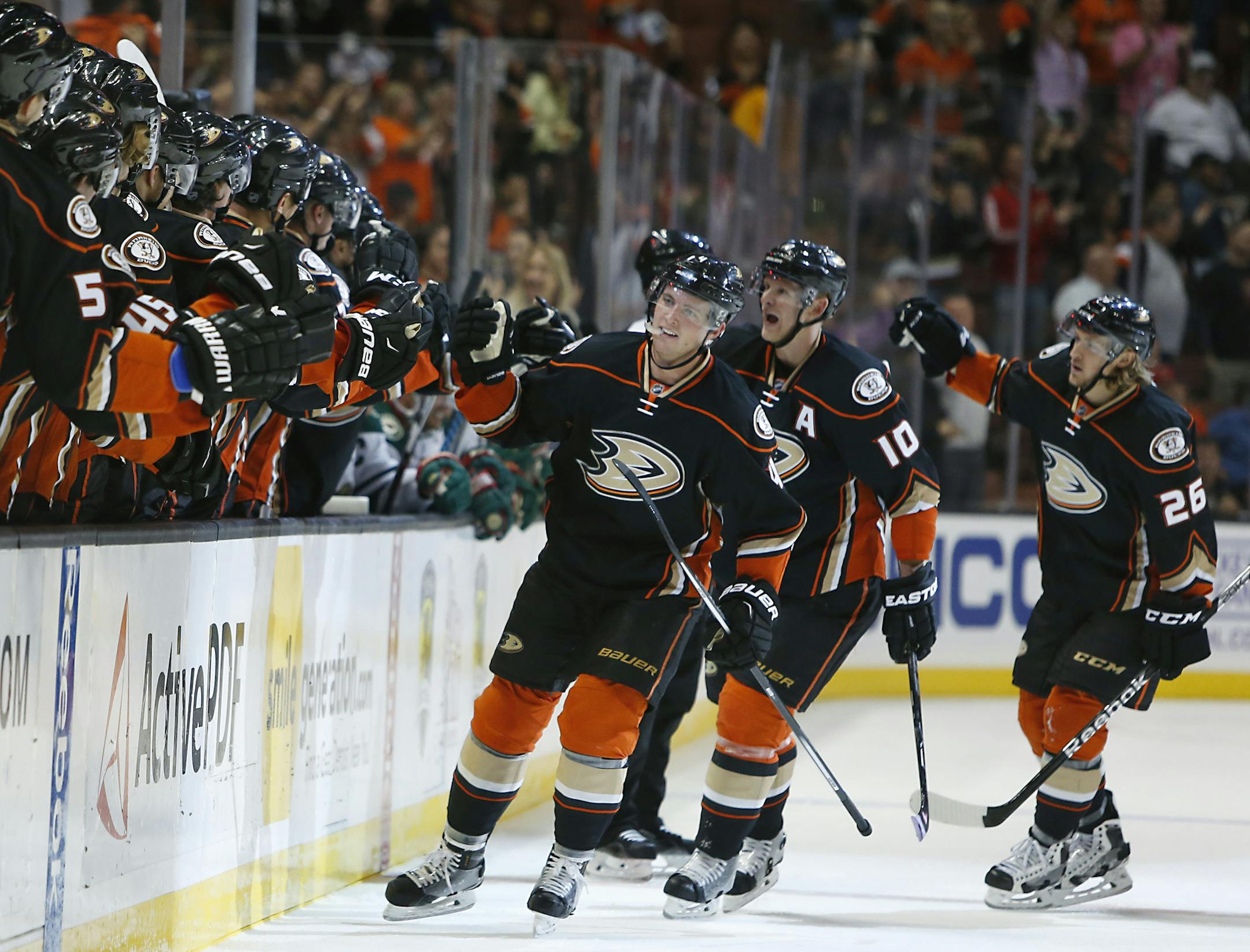 Anaheim Ducks' Cam Fowler, Corey Perry, and Carl Hagelin, from left, celebrate Fowler's goal in the first period of an NHL hockey game against the Minnesota Wild in Anaheim, Calif., Sunday, Oct.18, 2015. The Ducks won 4-1. (AP Photo/Christine Cotter)