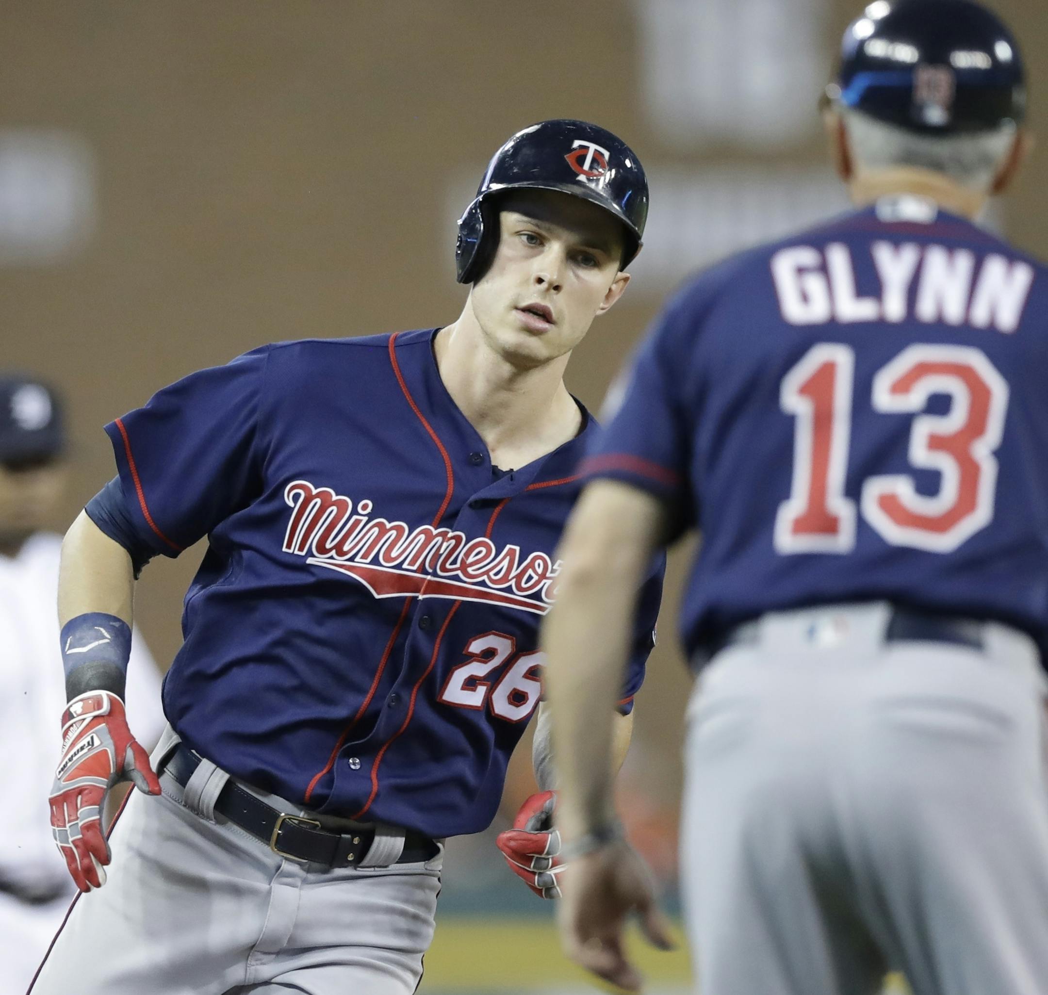 Minnesota Twins' Max Kepler is greeted by third base coach Gene Glynn after a solo home run during the third inning of a baseball game against the Minnesota Twins, Friday, Sept. 22, 2017, in Detroit. (AP Photo/Carlos Osorio)