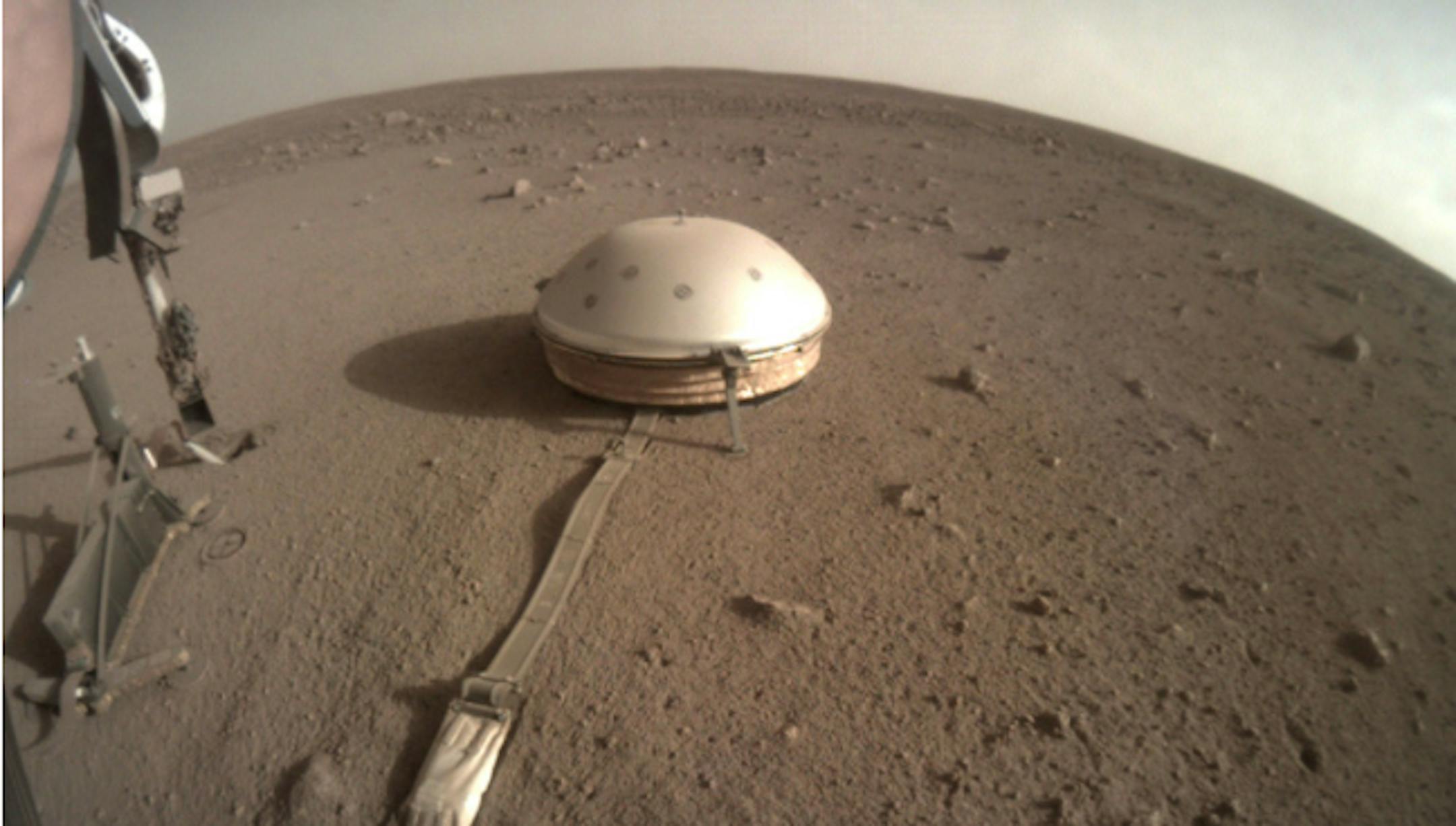 This Feb. 18, 2020 photo made available by NASA shows the InSight lander's dome-covered seismometer, known as SEIS, on Mars. On Monday, Feb. 24, 2020, scientists reported that the spacecraft has detected hundreds of quakes and even aftershocks that are regularly jolting the red planet.