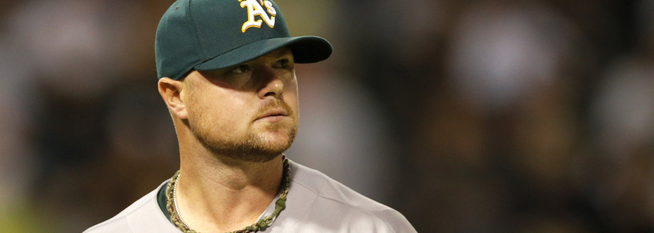 Oakland Athletics starting pitcher Jon Lester looks into the seats after the third inning of a baseball game against the Chicago White Sox, Tuesday, Sept. 9, 2014, in Chicago. (AP Photo/Charles Rex Arbogast)