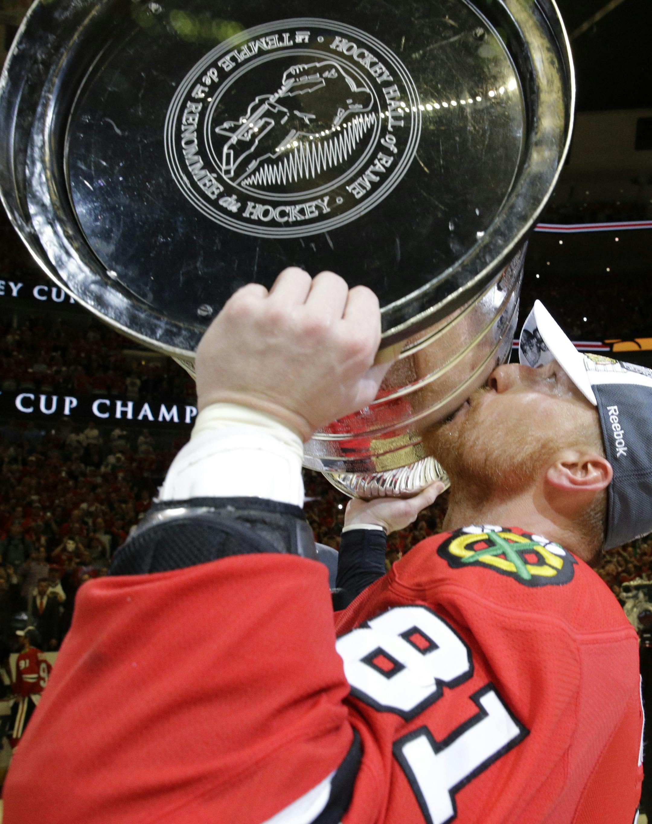 Chicago Blackhawks' Marian Hossa, of Slovakia, kisses the Stanley Cup Trophy after defeating the Tampa Bay Lightning in Game 6 of the NHL hockey Stanley Cup Final series on Monday, June 15, 2015, in Chicago. The Blackhawks defeated the Lightning 2-0 to win the series 4-2. (AP Photo/Nam Y. Huh) ORG XMIT: CXA196