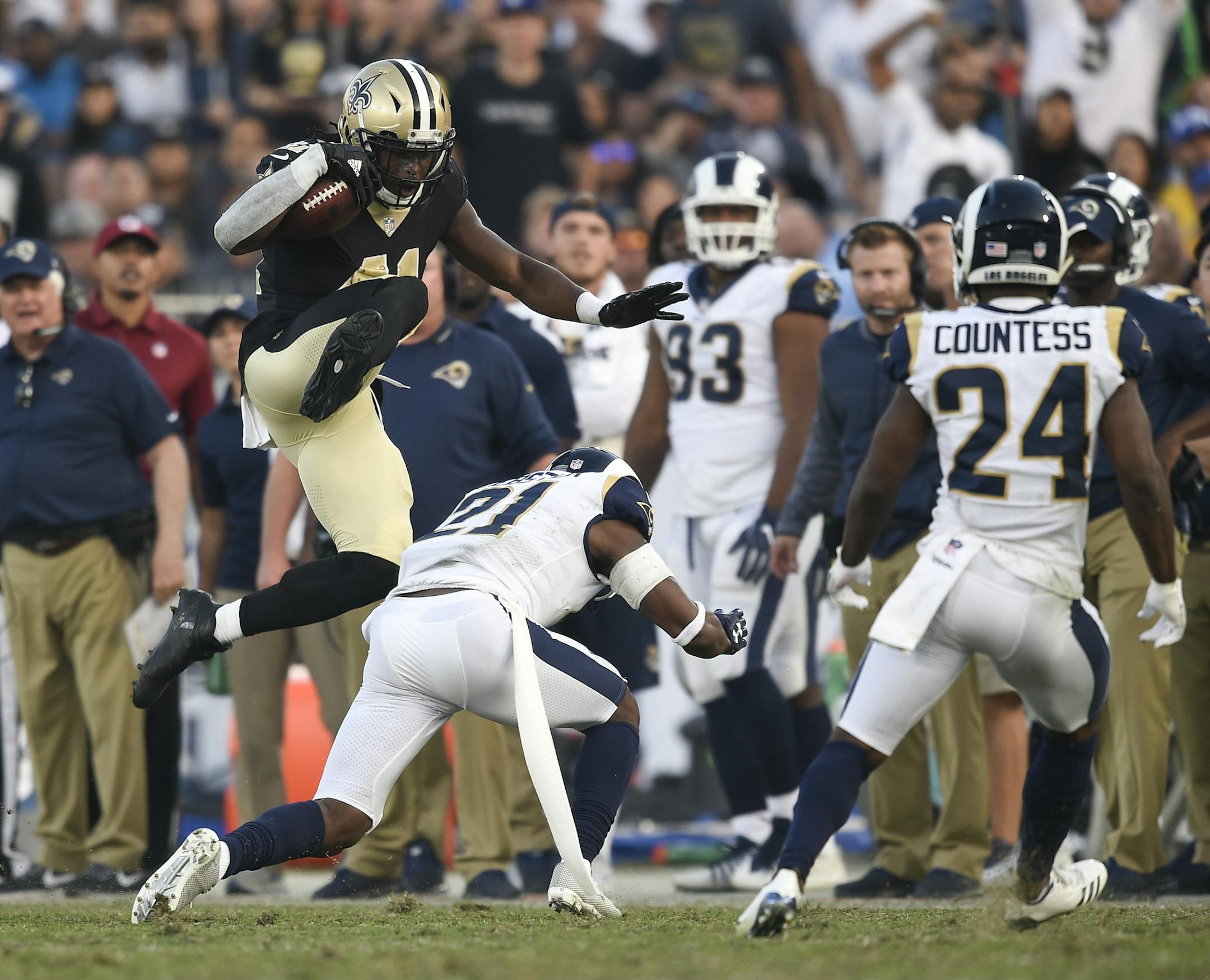New Orleans Saints running back Alvin Kamara, top, jumps over Los Angeles Rams cornerback Kayvon Webster during the second half of an NFL football game Sunday, Nov. 26, 2017, in Los Angeles. (AP Photo/Kelvin Kuo)