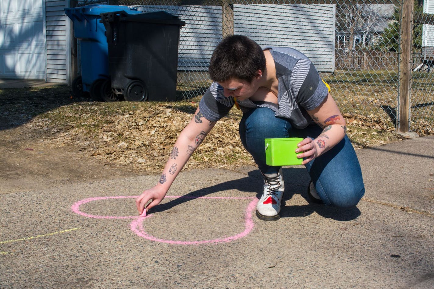 Chalk hearts and encouraging notes, like the ones Cedar Thomas drew, are one way neighbors are showing they're there for each other -- at a safe distance. Photo credit: Sophie Warrick