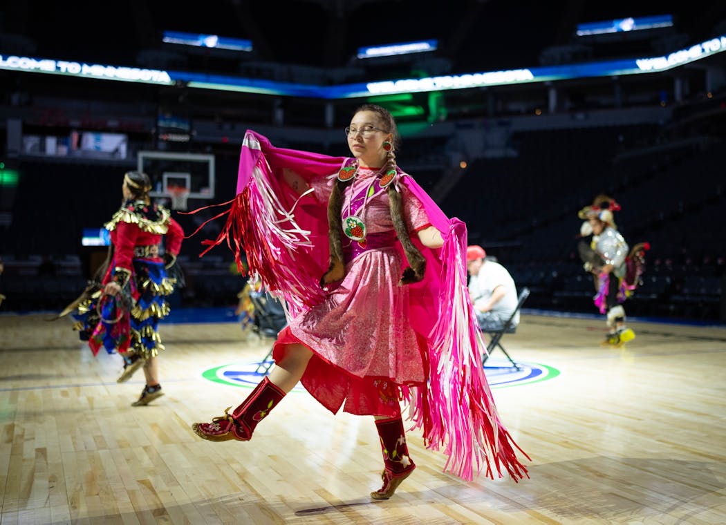 Fancy shawl dancer Caley Coyne, 19, of St. Paul performs moments after Alissa Pili arrived in Target Center for a surprise welcome event. Coyne also is of Alaska Native ancestry and grew up playing basketball. She says Pili will inspire 