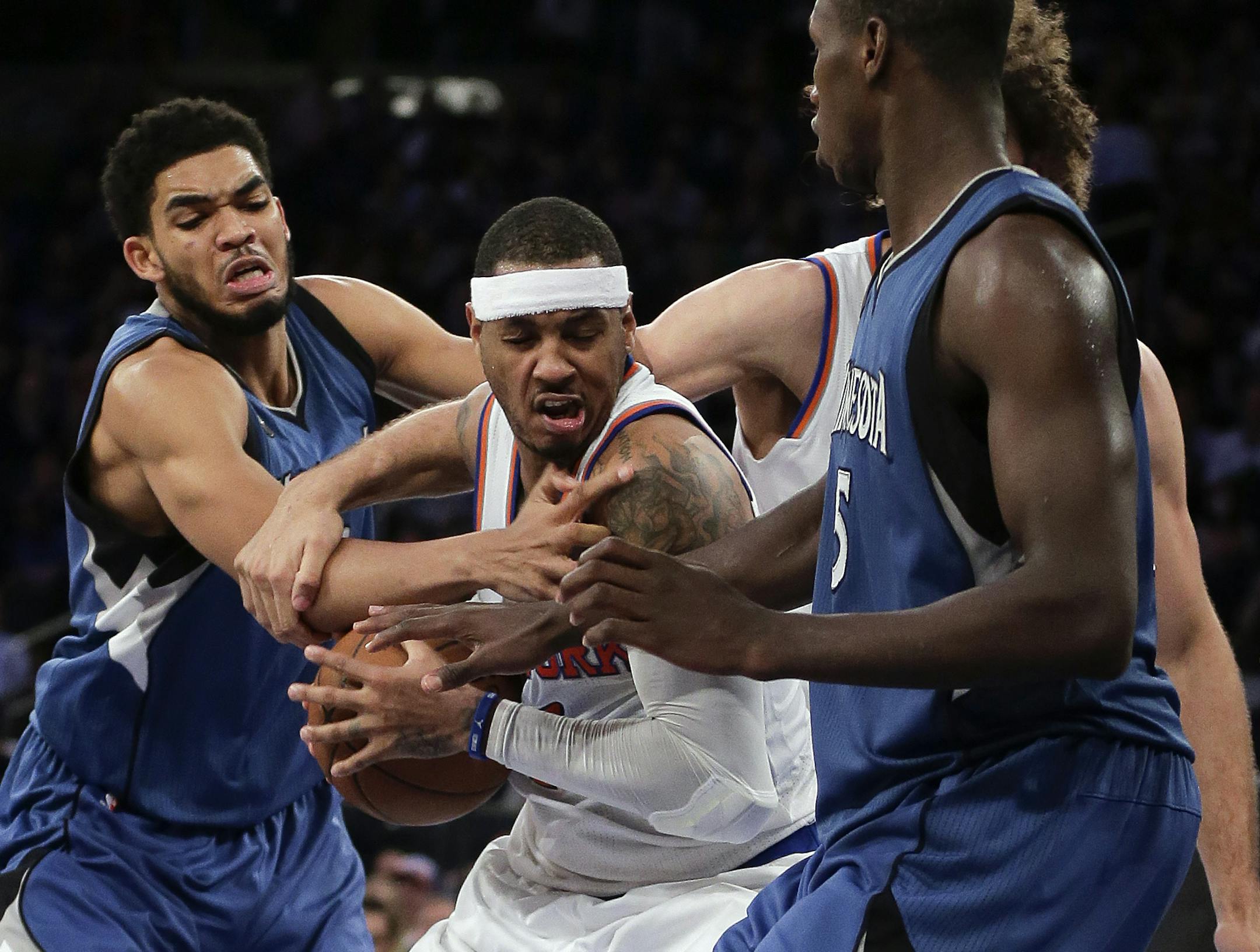 Knicks forward Carmelo Anthony, center, was double-teamed by the Timberwolves' Karl-Anthony Towns, left, and center Gorgui Dieng (5) during a December 2015 game in New York.