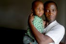 James Tuan held his 2-year-old son Jamel at his home in Brooklyn Center. Tuan and his girlfriend are from Liberia and have Temporary Protected Status,