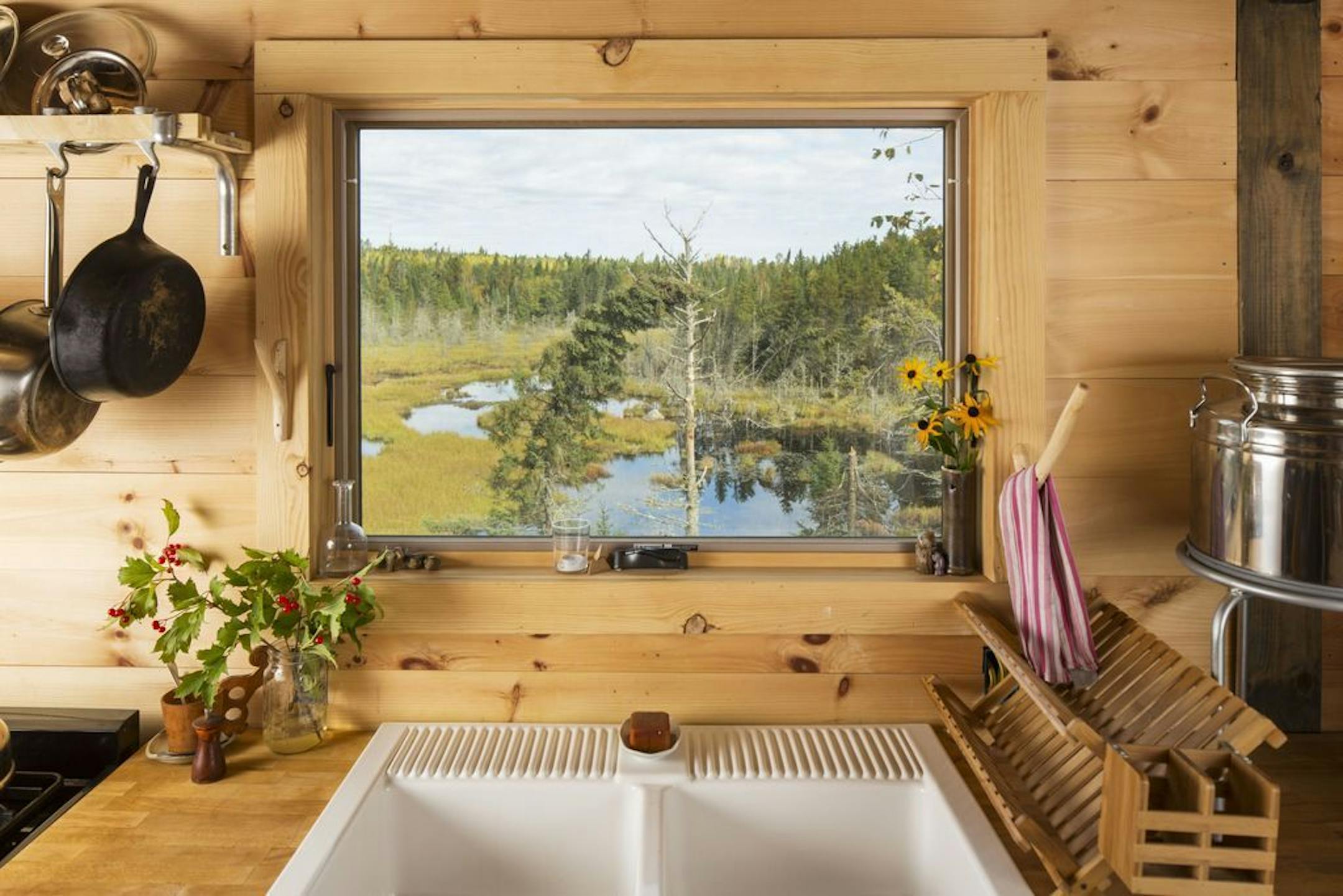 The "Zen" kitchen window frames views of the pond and wilderness setting.