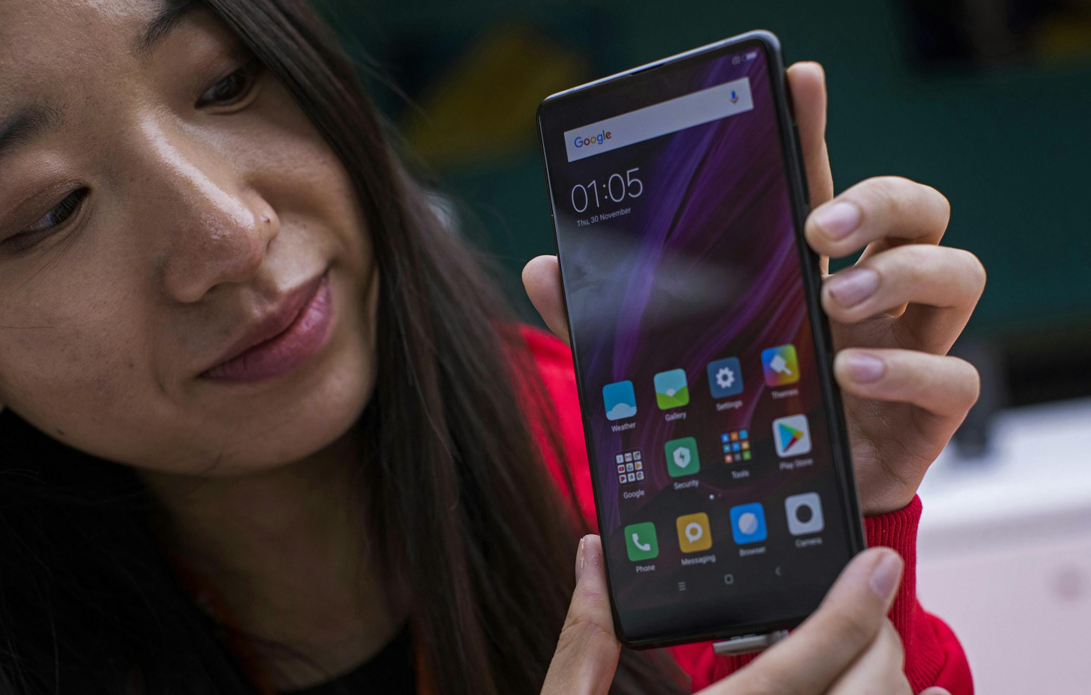 In this Feb. 26, 2018 file photo, a woman shows the new Xiaomi Mi MIX 2 during the Mobile World Congress wireless show, in Barcelona, Spain. Chinese smartphone maker Xiaomi filed documents Thursday, May 3, 2018, with Hong Kongís stock exchange operator for an initial public offering that could be the worldís biggest share sale in years. Beijing-based Xiaomi is the worldís fourth biggest smartphone maker by shipment volume, according to International Data Corp.(AP Photo/Emilio More