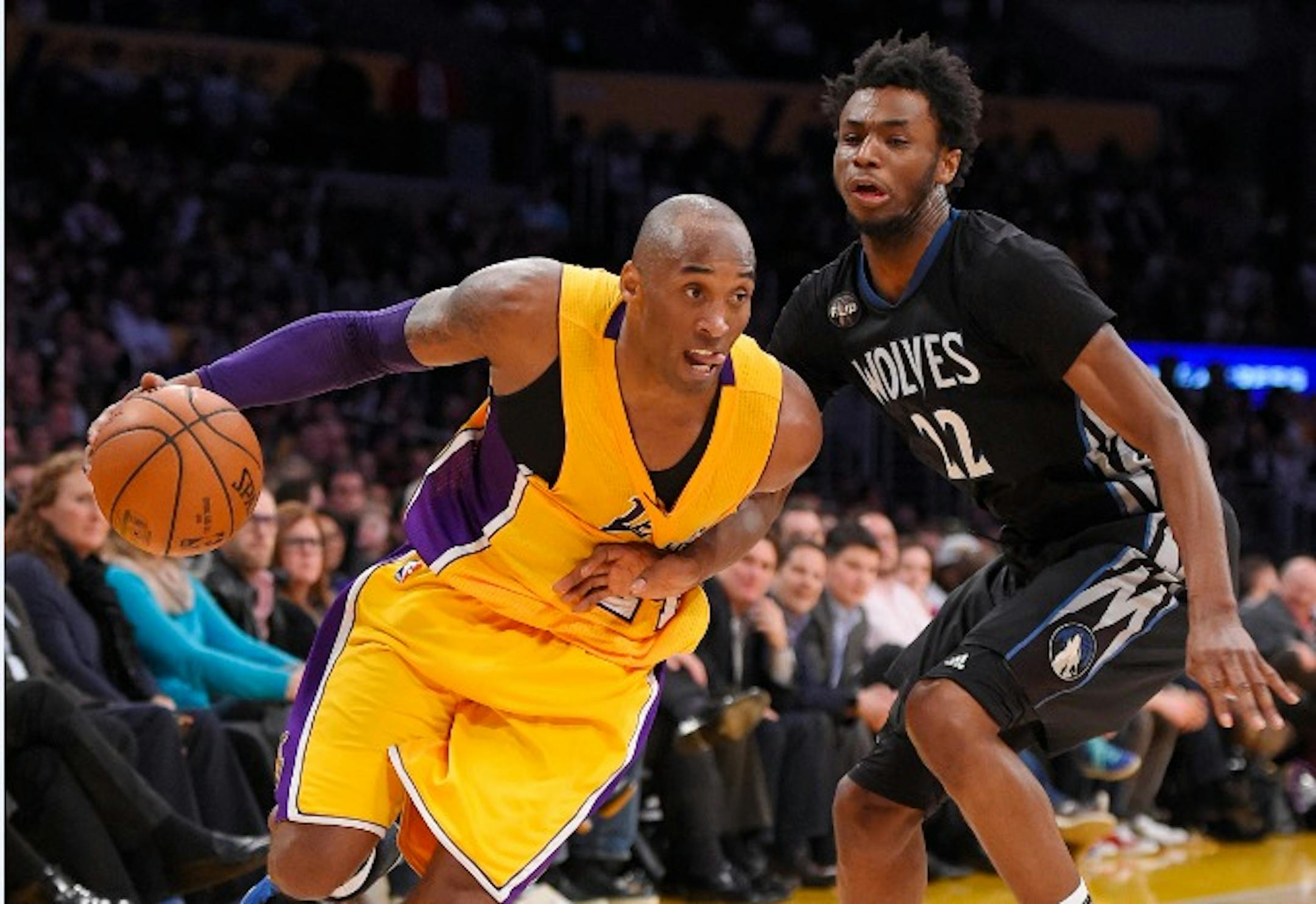 Los Angeles Lakers forward Kobe Bryant, left, drives past Minnesota Timberwolves guard Andrew Wiggins during the second half of an NBA basketball game Tuesday, Feb. 2, 2016, in Los Angeles. The Lakers won 119-115. (AP Photo/Mark J. Terrill)