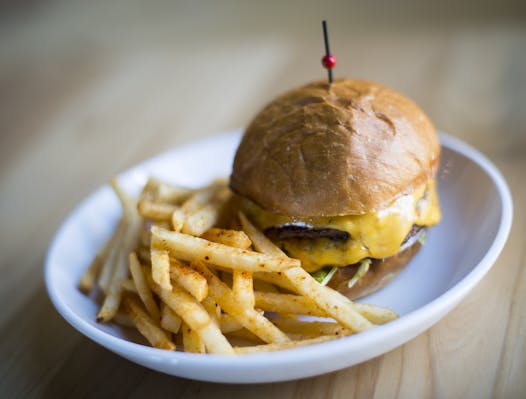The Surly Burger with American cheese, lettuce, tarragon-kissed mayo-and-ketchup sauce and fries.