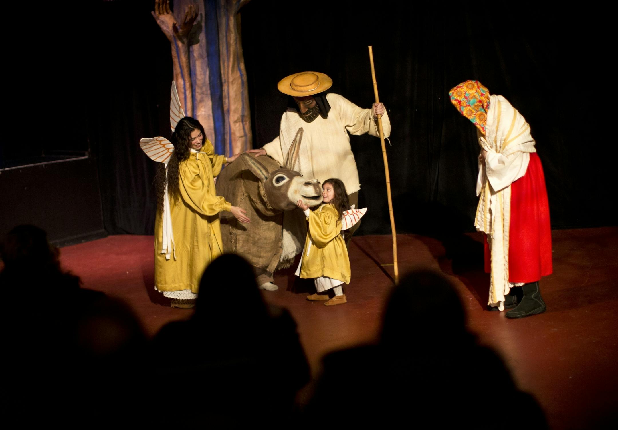 Three-year-old Imix Ybarra, playing an angel, led the donkey across the stage in a scene where Mary and Joseph travel to Bethlehem to find shelter in the Heart of the Beast Puppet and Mask Theatre's La Natividad on December 13, 2012 in Minneapolis, Minn.
