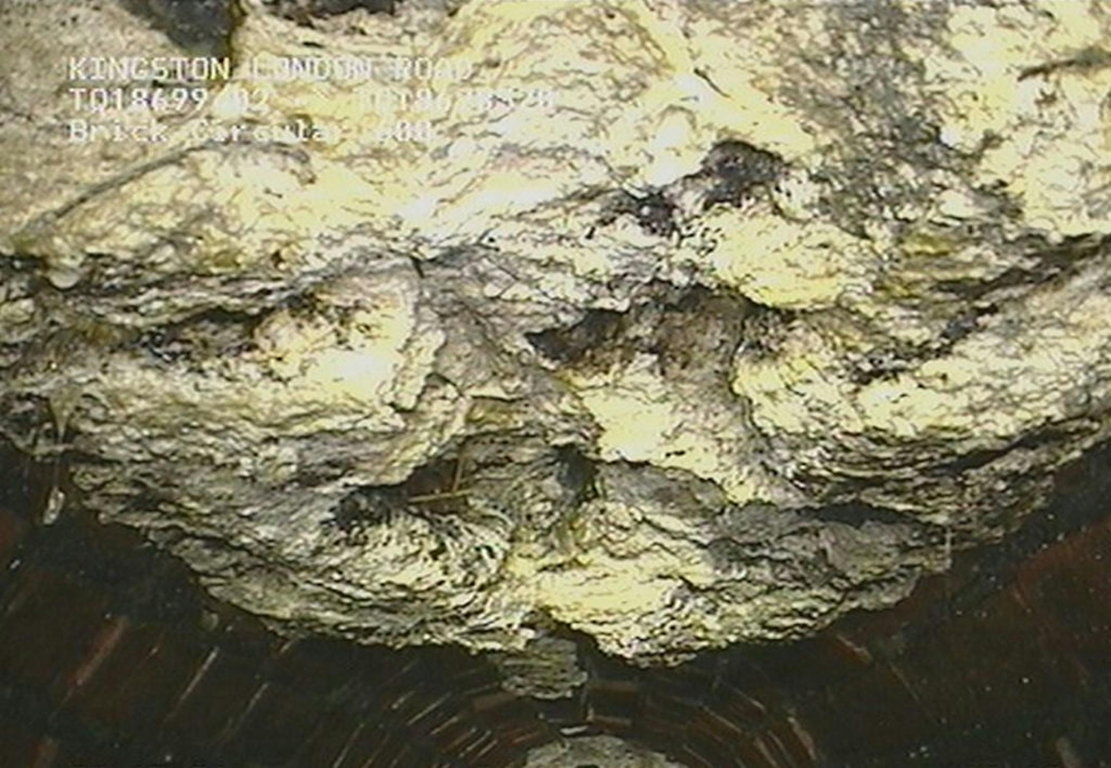 In this undated image released by Thames Water company, showing part of a 15-ton lump of fat and other debris coagulated inside a main London city sewer, which they have spent many days clearing from the drain, it is announced Tuesday Aug, 6, 2013. Utility company Thames Water says it has cleared what it calls the biggest "fatberg" ever recorded in Britain, a 15-ton blob of congealed fat and baby wipes the size of a bus, which was lodged inside a London sewer drain.