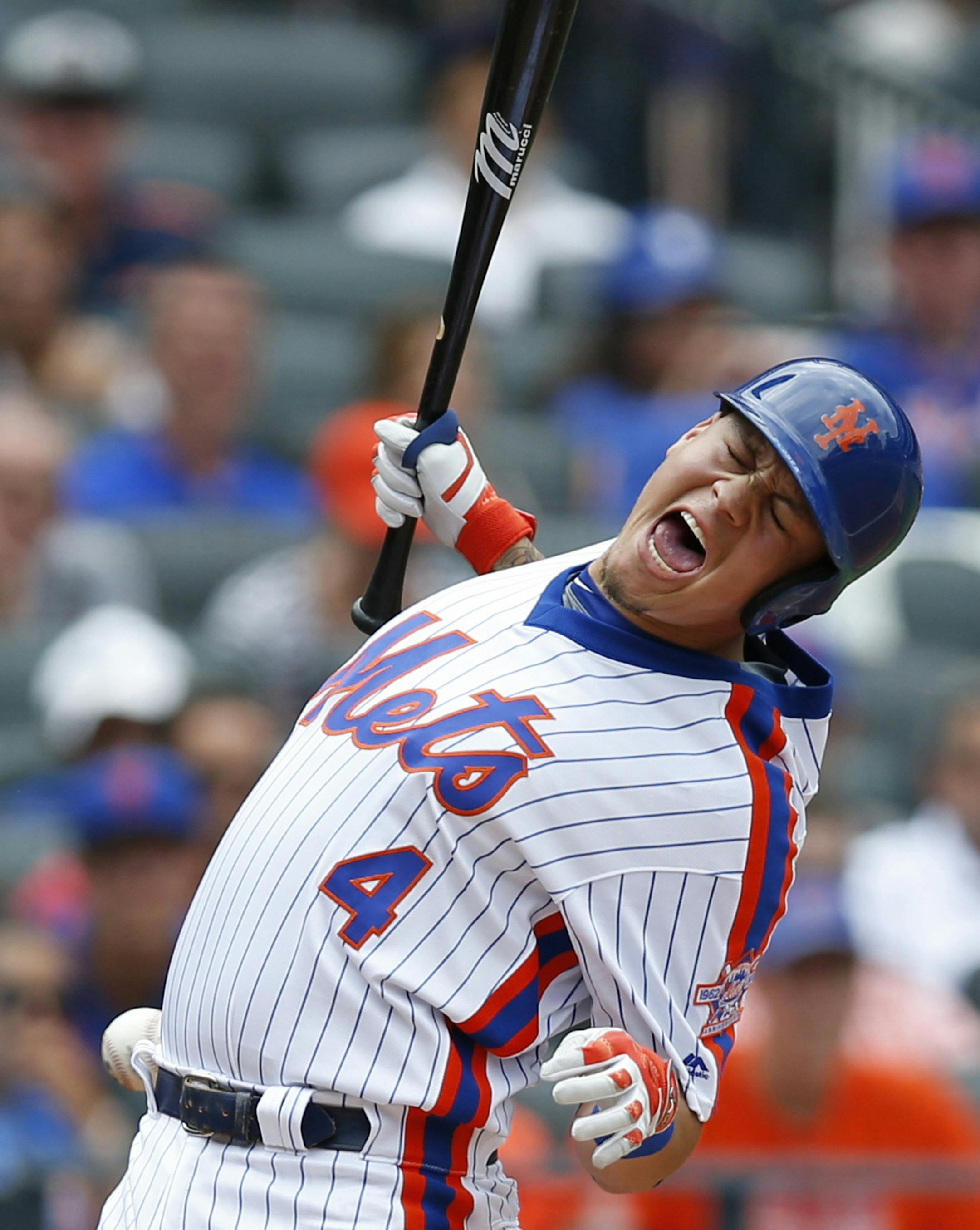 New York Mets' Wilmer Flores reacts as he is hit by a pitch during the third inning of a baseball game against the Colorado Rockies, Sunday, July 31, 2016, in New York. (AP Photo/Kathy Willens)