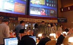 Gamblers line up to place bets on the NCAA men's college basketball tournament at the Borgata casino in Atlantic City N.J., Thursday, March 21, 2019. 
